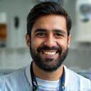Ravi Patel, Senior Grooming Specialist, smiling in uniform