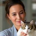 Sienna Moore, Animal Wellness Consultant, holding a cat
